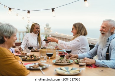 Happy Multiracial Senior Friends Having Fun Dining Together On House Patio - Elderly Lifestyle People And Food Concept 