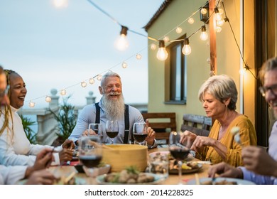 Happy Multiracial Senior Friends Having Fun Dining Together On House Patio - Elderly Lifestyle People And Food Concept 