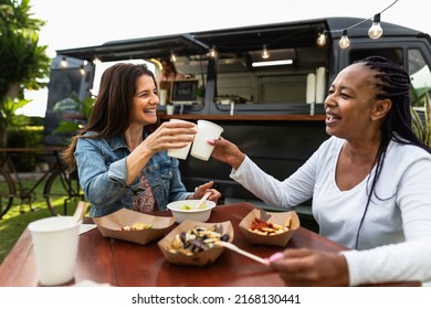 Happy Multiracial Senior Friends Having Fun Eating In A Street Food Truck Market