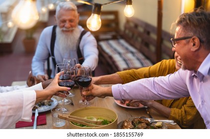 Happy Multiracial Senior Friends Toasting With Red Wine Glasses Together On House Patio Dinner - Elderly Lifestyle People And Food Concept 