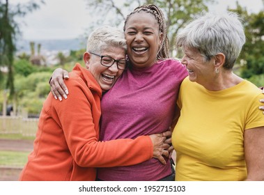 Happy multiracial senior women having fun together at park - Elderly generation people hugging each other outdoor - Shutterstock ID 1952715103