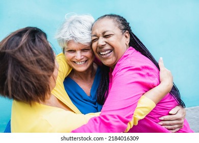 Happy Multiracial Senior Women Having Fun Hugging Each Other Outdoor - Older Community Lifestyle