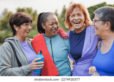 Happy multiracial senior women having fun together after sport workout at city park - Joyful elderly female friends and healthy lifestyle concept - Powered by Shutterstock