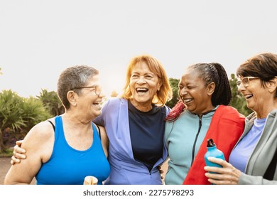 Happy multiracial senior women having fun after workout exercises in the park - Powered by Shutterstock