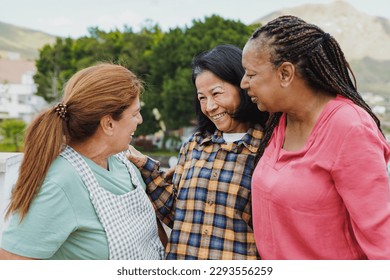 Happy multiracial senior women having fun together outdoor - Elderly generation people hugging each other at home terrace - Powered by Shutterstock