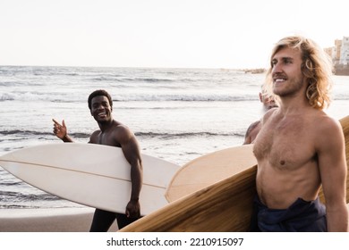 Happy Multiracial Surfer Friends Holding Surf Boards After Extreme Water Sport Training At The Beach - Focus On African Man Face.