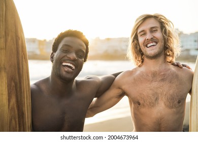 Happy Multiracial Surfers Having Fun On The Beach After Surf Session - Soft Focus On African Man Face