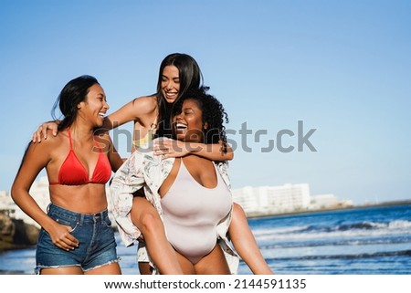 Happy multiracial women with different bodies and skins having fun in summer day on the beach - Focus on curvy girl face
