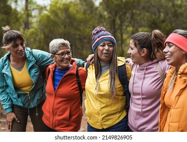Happy multiracial women having fun together during trekking day at mountain forest