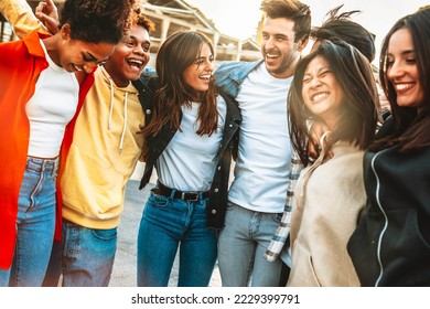 Happy multiracial young people celebrating party together outside - Group of university students having fun in college campus - Friendship concept with guys and girls hanging out on city street
