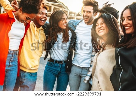 Happy multiracial young people celebrating party together outside - Group of university students having fun in college campus - Friendship concept with guys and girls hanging out on city street