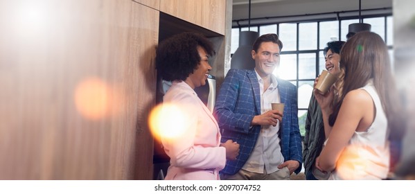 Happy Multiracial Young People Friends Talking Laughing At Group Meeting,diverse Students Drinking Coffee Having Fun Together Enjoy Multi-ethnic Friendship Pleasant Conversation In Modern Office.