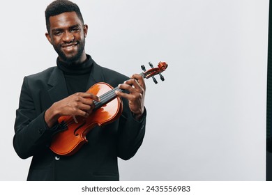 Happy musician presenting violin on green screen and white background for creative design projects - Powered by Shutterstock