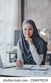 Happy Muslim Business Women In Hijab At Work Smiling Arab Woman Taking Notes And Work On Laptop