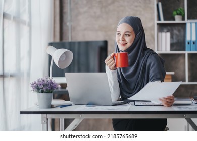 Happy Muslim Business Women In Hijab At Work Smiling Arab Woman Taking Notes And Work On Laptop