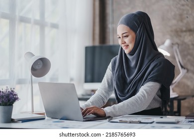 Happy Muslim Business Women In Hijab At Work Smiling Arab Woman Taking Notes And Work On Laptop