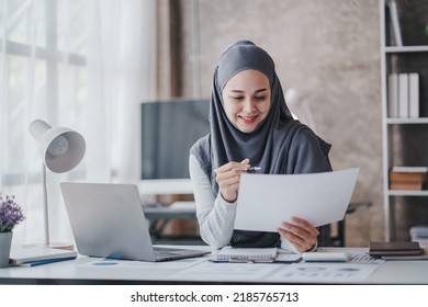 Happy Muslim Business Women In Hijab At Work Smiling Arab Woman Taking Notes And Work On Laptop