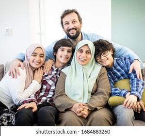 Happy Muslim family portrait on sofa