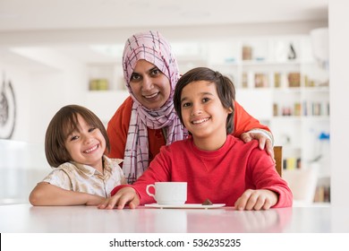 Happy Muslim Middle Eastern mother with son at new modern home family at new modern home - Powered by Shutterstock