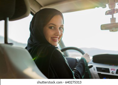 Happy Muslim Woman Driving Car