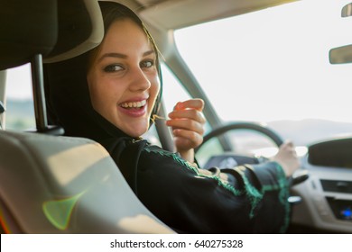 Happy Muslim Woman Driving Car