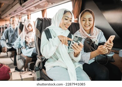 happy muslim woman using phone while travel by bus during eid mubarak holiday - Powered by Shutterstock