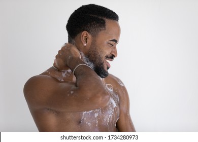 Happy Naked African American Man Stand Under Water Flow Wash With Foamy Gel In Home Bathroom, Smiling Handsome Young Biracial Male Take Morning Daily Shower In Bath, Body Hygiene Concept