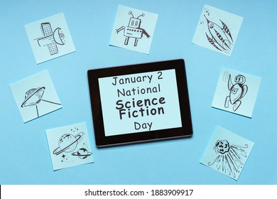 Happy National Science Fiction day. Freehand drawings about science fiction on blue background. Calendar date January 02, text SCIENCE FICTION DAY on tablet screen. Flat lay, top view - Powered by Shutterstock