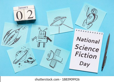 Happy National Science Fiction day. Freehand drawings about science fiction on blue background. Calendar date January 02, text SCIENCE FICTION DAY on white notebook page. Flat lay, top view - Powered by Shutterstock