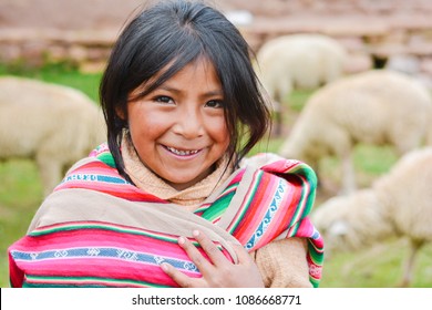 Happy native american girl wearing ethnic aymara cloth. Sheep on the background. - Shutterstock ID 1086668771