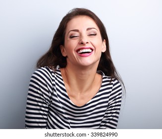 Happy Natural Toothy Laughing Casual Woman With Wide Open Mouth And Closed Eyes On Blue Background