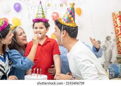 Happy Ndian Asian Multi Generational Family Celebrate Children's Birthday Party. Kid Eat Cake