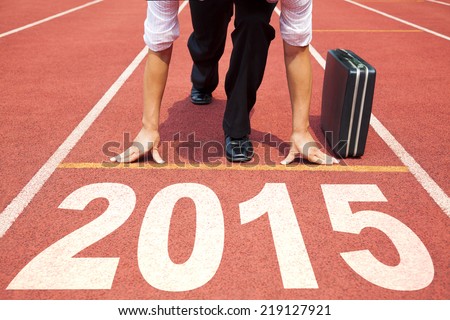 happy new year 2015. businessman preparing for running with briefcase