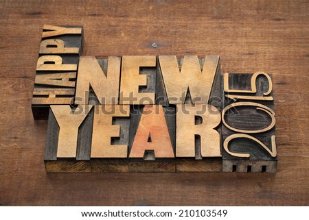 Happy New Year 2015 greetings  - text in vintage letterpress wood type blocks on a grunge wooden background