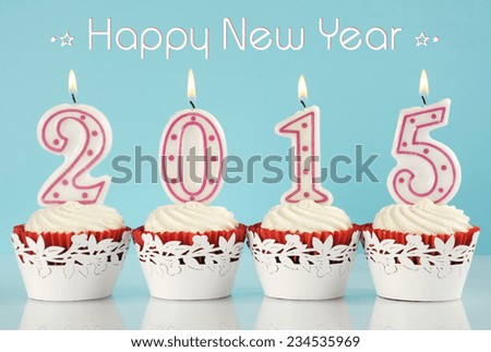 Happy New Year for 2015 red velvet cupcakes in red and white theme with lit candles and pale blue and white background, with sample text.