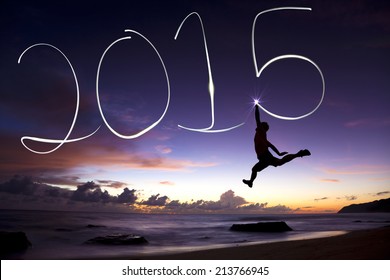 Happy New Year 2015.young Man Jumping And Drawing 2015 By Flashlight