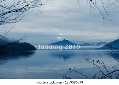 Happy New Year, 2019, Geek Greetings With Mountain And Lake Canadian Landscape And A Loading Wheel