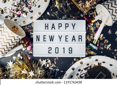 Happy New Year 2019 On Light Box With Party Cup,party Blower,tinsel,confetti.Fun Celebrate Holiday Party Time Table Top View