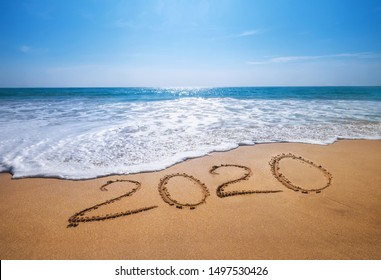 Happy New Year 2020 is coming concept sandy tropical ocean beach lettering. Exotic New Year celebration concept image.