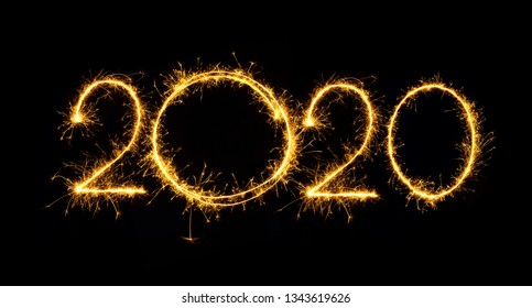 Happy New Year 2020. Number 2020 written sparkling sparklers isolated on black background With Copy Space For Text. Beautiful Glowing overlay template for holiday greeting card.
