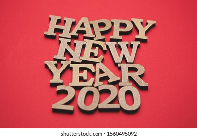 Happy New Year 2020 Red Wallpaper.Vibrant Background With Rustic Wooden Letters And Figures.Eco Friendly Home Decor For Winter Holiday Season