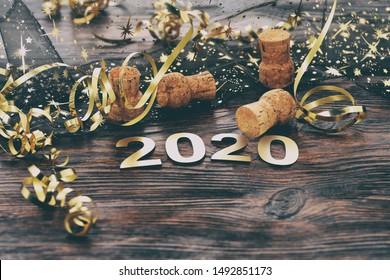 Happy New Year 2020. Symbol from number 2020 on wooden background - Shutterstock ID 1492851173