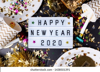 Happy New Year 2020 Table With Modern Light Box With Party Cup,party Blower,tinsel,confetti.Fun Celebration Holiday Party Time Table Flat Lay Invitation Or Greeting Card.new Year Eve Concept