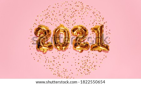 Happy New year 2021 celebration. Bright gold balloons figures, New Year Balloons with glitter stars on pink background. Christmas and new year celebration. Gold foil balloons 2021 gift card