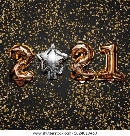 Happy New year 2021 celebration. Bright gold balloons figures, New Year Balloons with glitter stars on dark background. Christmas and new year celebration. Gold foil balloons 2021 gift card