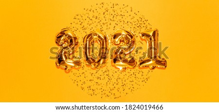 Happy New year 2021 celebration. Bright gold balloons figures, New Year Balloons with glitter stars on bright yellow background. Christmas and new year celebration. Gold foil balloons 2021 gift card