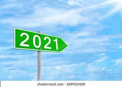 Happy New Year 2021 Concept With  Road Sign Against Blue Sky