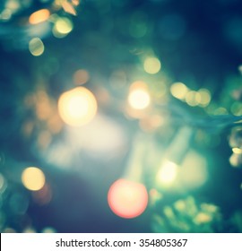 Happy new year 2021 concept: Abstract bokeh light bulb and blurred green christmas tree background