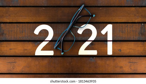 Happy New Year 2021. Year 2021 With Glasses On Wooden Table