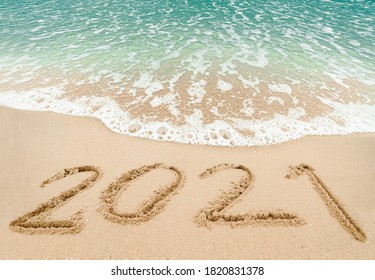 Happy New Year 2021, Lettering On The Beach With Wave And Blue Sea. Numbers 2021 Year On The Sea Shore, New Years Concept.